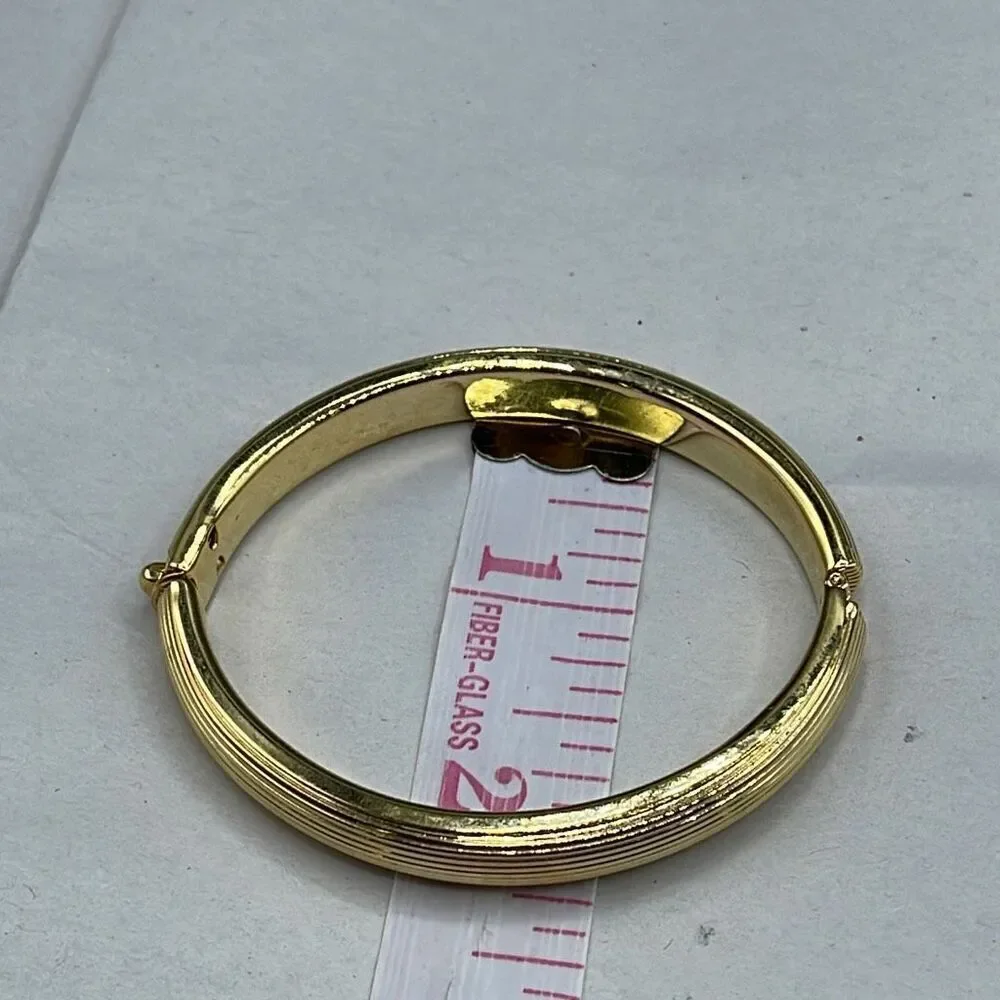 Vintage ribbed gold colored hinged bangle